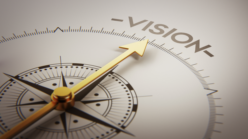 Gold compass needle points toward the word VISION, symbolizing direction and purpose.